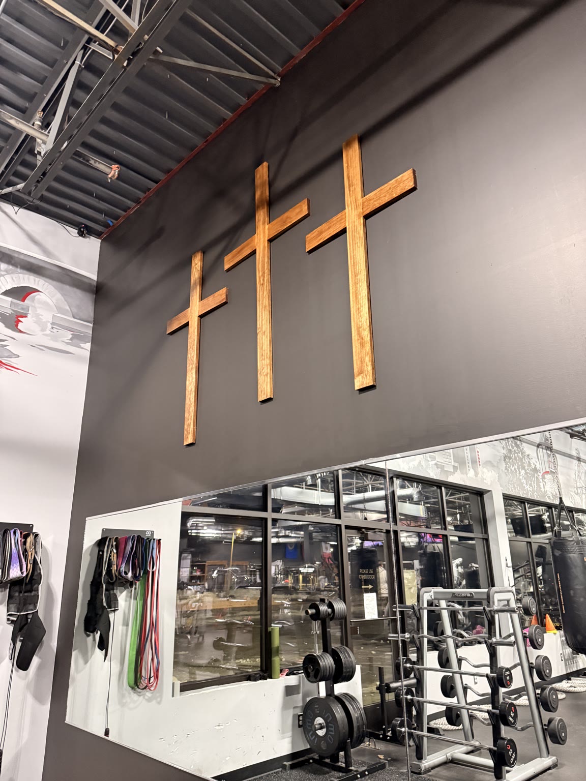 Three wooden crosses displayed inside Ace Athletics Gym