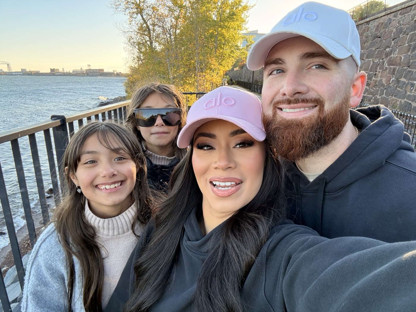 John, Kelly, and their daughters together by the waterfront