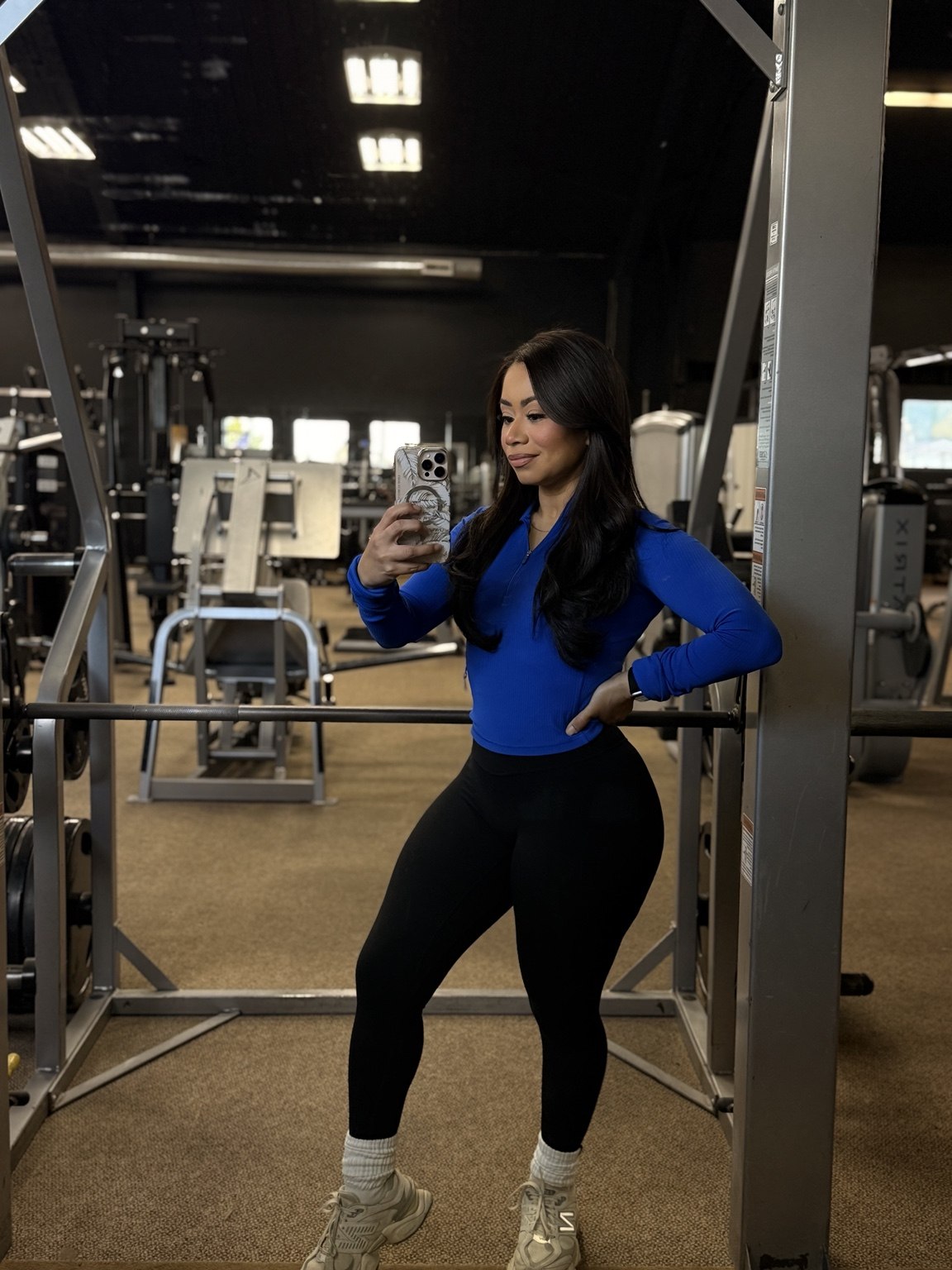 Kelly in workout clothes on the Ace Athletics equipment floor