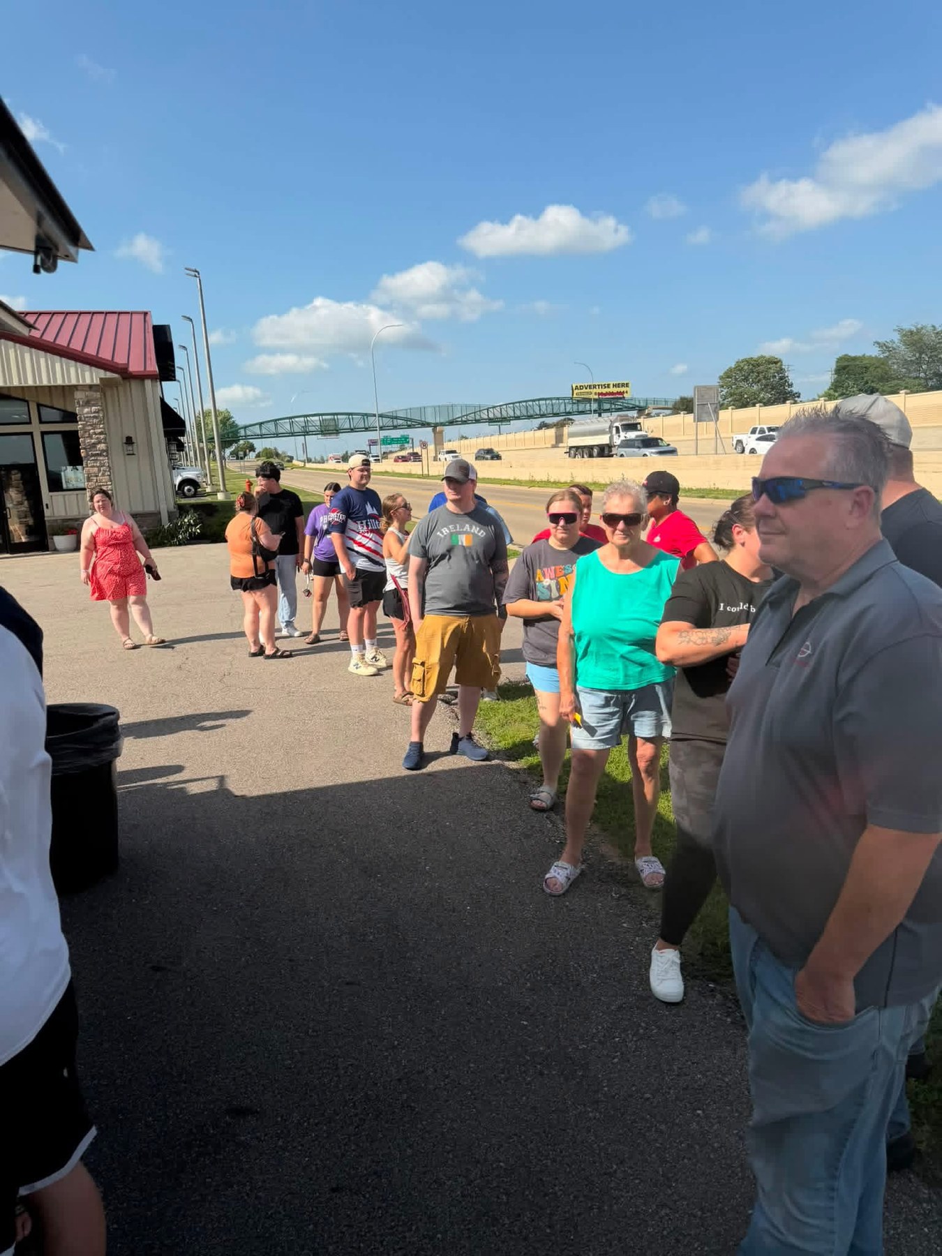 Community members gathered outside Ace Athletics for the food truck